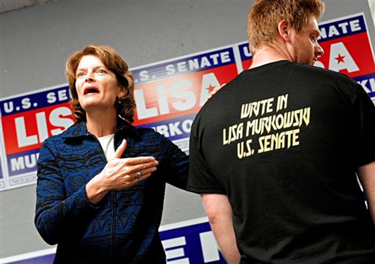 FILE - In this Sept. 24, 2010, file photo Alaska's Republican U.S. Senator Lisa Murkowski, left, shows off a T-shirt worn by one of her supporters, Alex Grundmann, at a rally at the Senator's new  campaign headquarters in Juneau, Alaska. 24, 2010. Murkowski, who lost the Alaska GOP nomination to tea party favorite Joe Miller, launched a write-in campaign to try to keep the seat she has held since 2002. Political insiders say the effort probably will fail, but it's hard to predict whether Murkowski would pull more votes from Miller or from Democrat Scott McAdams. (AP Photo/Chris Miller, File) (AP)