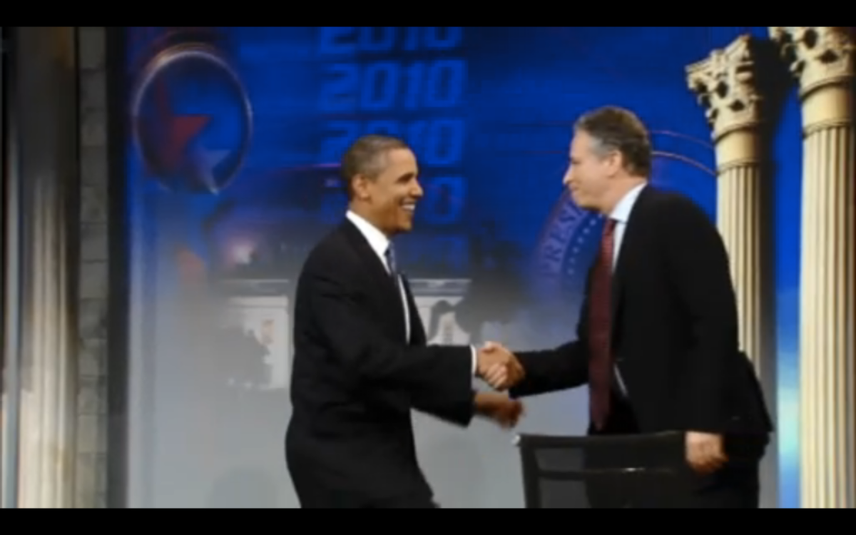 Obama and Stewart shake hands before a live audience in Washington