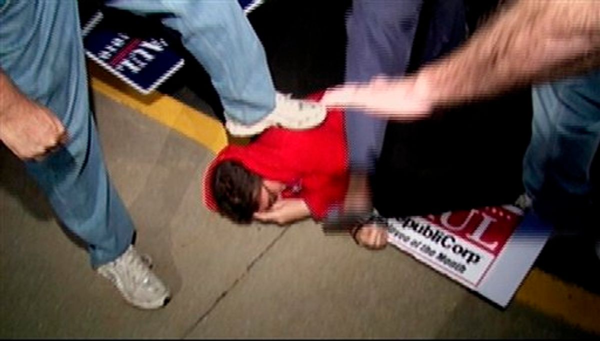 In this Monday, Oct. 25, 2010 image taken from video and released by WDRB/Louisville, Lauren Valle of liberal group MoveOn.org, seen in red, is held on the ground by supporters of Republican U.S. Senate candidate Rand Paul as she tries to confront the candidate, in Lexington Ky., after Paul and Democratic opponent Jack Conway debated. (AP Photo/WDRB/Louisville) MANDATORY CREDIT (AP)