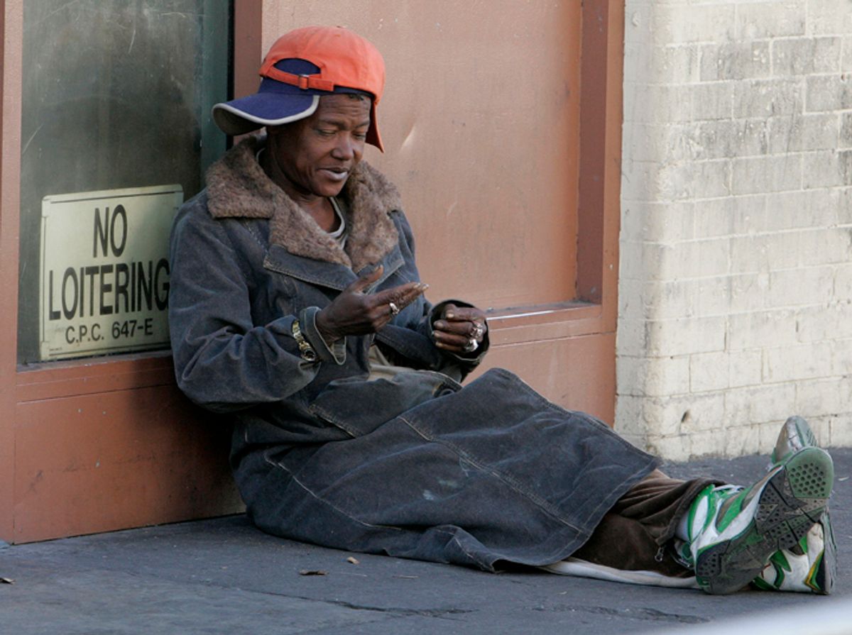 A homeless person sits on the sidewalk on skid row in downtown Angeles, California November 25, 2009. REUTERS/Fred Prouser    (UNITED STATES SOCIETY)   (Â© Fred Prouser / Reuters)