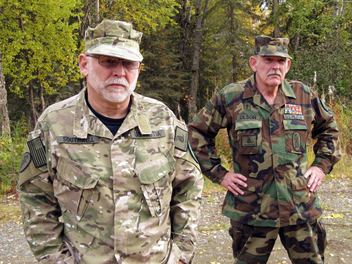**ADVANCE FOR WEEKEND EDITIONS, NOV. 21-22** In this photo taken Tuesday Sept. 29, 2009, Ray Southwell, left, and Norm Olson, members of the Alaska Citizens Militia stand by the woods near their home in Nikiski, Alaska. Olson's genial tone belies his reputation as a radical militiaman, yet here he is, at 63, an affable grandfather explaining why Americans should arm themselves against their government. Olson's militia is minuscule at the moment, but there has been a resurgence of the militia movement nationwide, in part coinciding with the advent of the Obama administration. (AP Photo/Rachel D'Oro) (Rachel D'oro)
