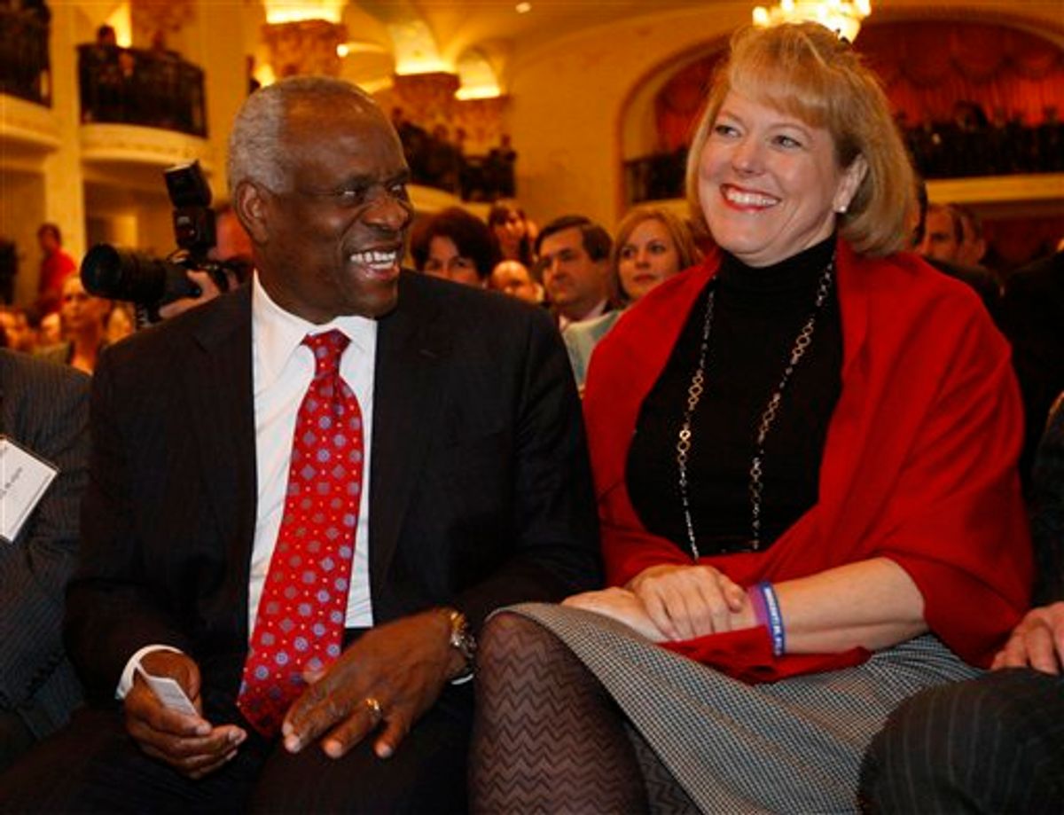 FILE - In this Nov. 15, 2007, photo, Supreme Court Justice Clarence Thomas, left, sits with his wife Virginia Thomas, as he is introduced at the Federalist Society in Washington, where he spoke about his new book and took questions from the audience. Virginia Thomas is asking Anita Hill to apologize for accusing the justice of sexually harassing her, 19 years after Thomas' confirmation hearing spawned a national debate about harassment in the workplace.(AP Photo/Charles Dharapak) (AP)