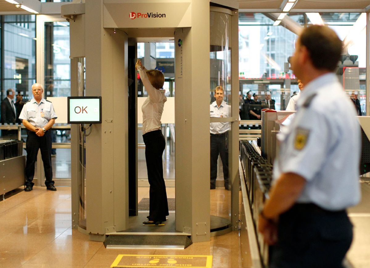 A security official demonstrates a full body scanner during a photocall at Departure Gate 2 at Hamburg Airport September 27, 2010. Germany started on Monday the voluntary use of two 'L-3  Provision ATD' body scanners for a test period over the next six months at the airport.   REUTERS/Christian Charisius (GERMANY - Tags: TRANSPORT SCI TECH)  (Â© Christian Charisius / Reuters)