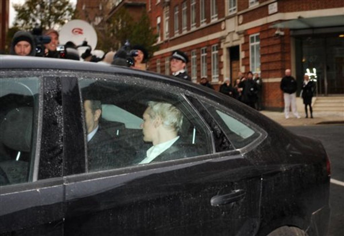 WikiLeaks founder Julian Assange, back to camera,  is driven into Westminster Magistrates Court in London Tuesday Dec. 7, 2010 after being arrested on a European Arrest Warrant.  Assange is appearing at the court for his extradition hearing for sexual assault allegations in Sweden.(AP Photo/ Stefan Rousseau/PA) UNITED KINGDOM OUT NO SALES NO ARCHIVE (AP)