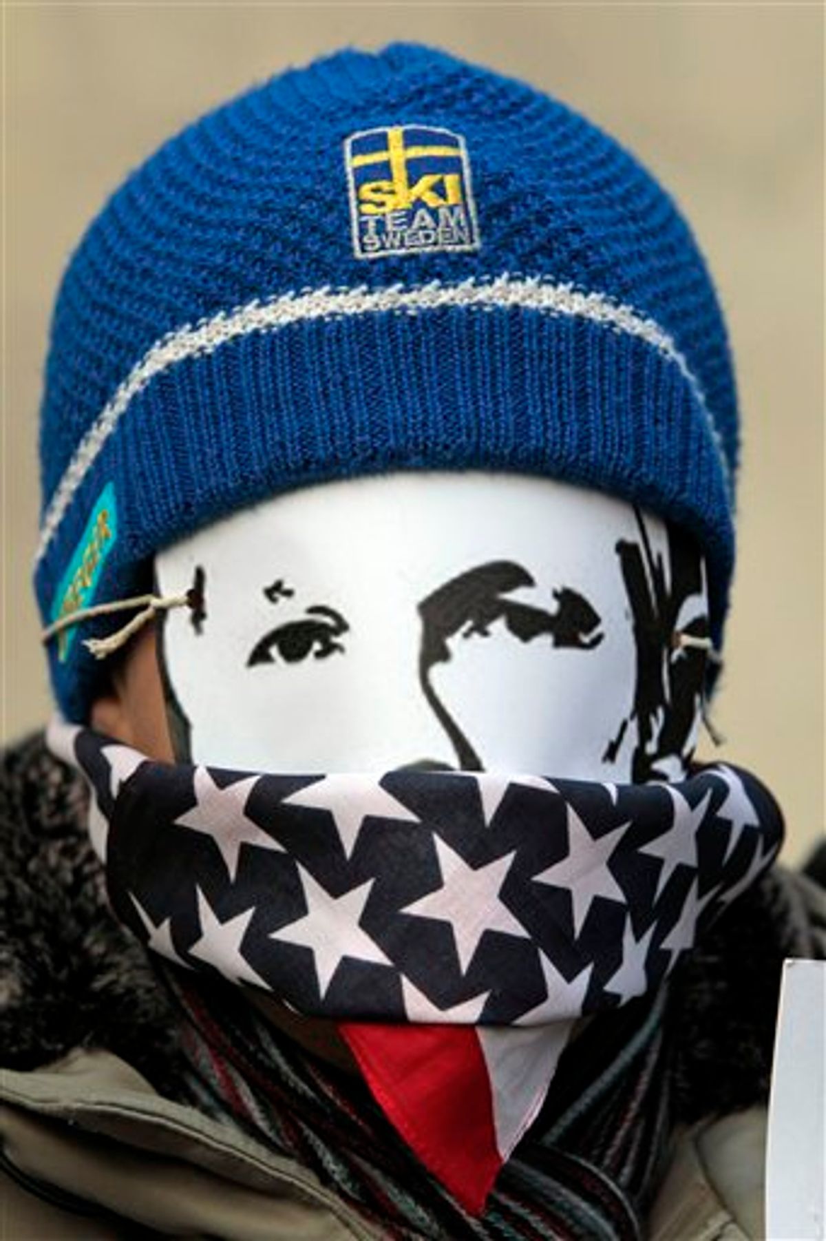 A supporters of WikiLeaks founder Julian Assange, wearing a mask depicting him and a US flag on his mouth, partiipates at  demonstrate outside theS wedish Embassy In central London, Monday, Dec. 13, 2010 Assange remains in a U.K. jail ahead of a Dec. 14 hearing where he plans to fight Sweden's request to extradite him to face sex crimes allegations there. (AP Photo/Lefteris Pitarakis)  (AP)