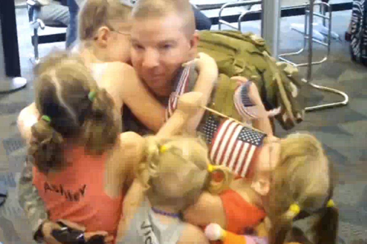 A servicemember greets his family at the airport.