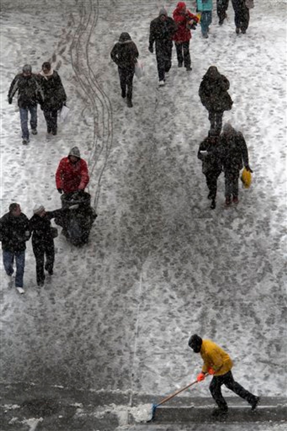 A maintenance worker clears snow from the sidewalk during a snowstorm on Broadway in New York's Times Square,  Sunday, Dec. 26, 2010 in New York.  (AP Photo/Mary Altaffer)  (AP)