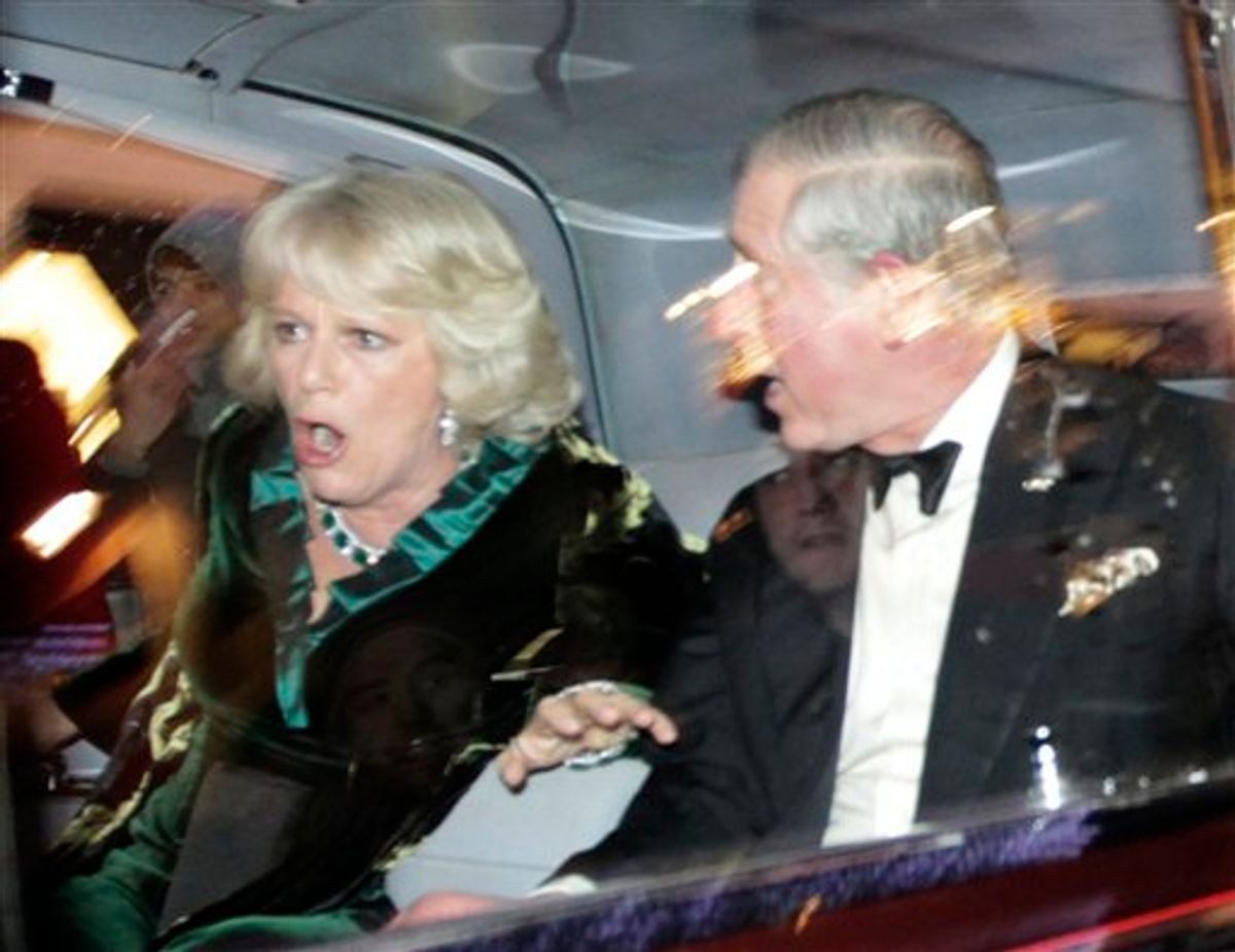 Britain's Prince Charles and Camilla, Duchess of Cornwall, react as their car is attacked by angry protesters in London, Thursday, Dec. 9, 2010. An Associated Press photographer saw demonstrators kick the car in Regent Street, in the heart of London's shopping district. The car then sped off. Charles' office, Clarence House, confirmed that "their royal highnesses' car was attacked by protesters on the way to their engagement at the London Palladium this evening, but their royal highnesses are unharmed." (AP Photo/Matt Dunham) (AP)