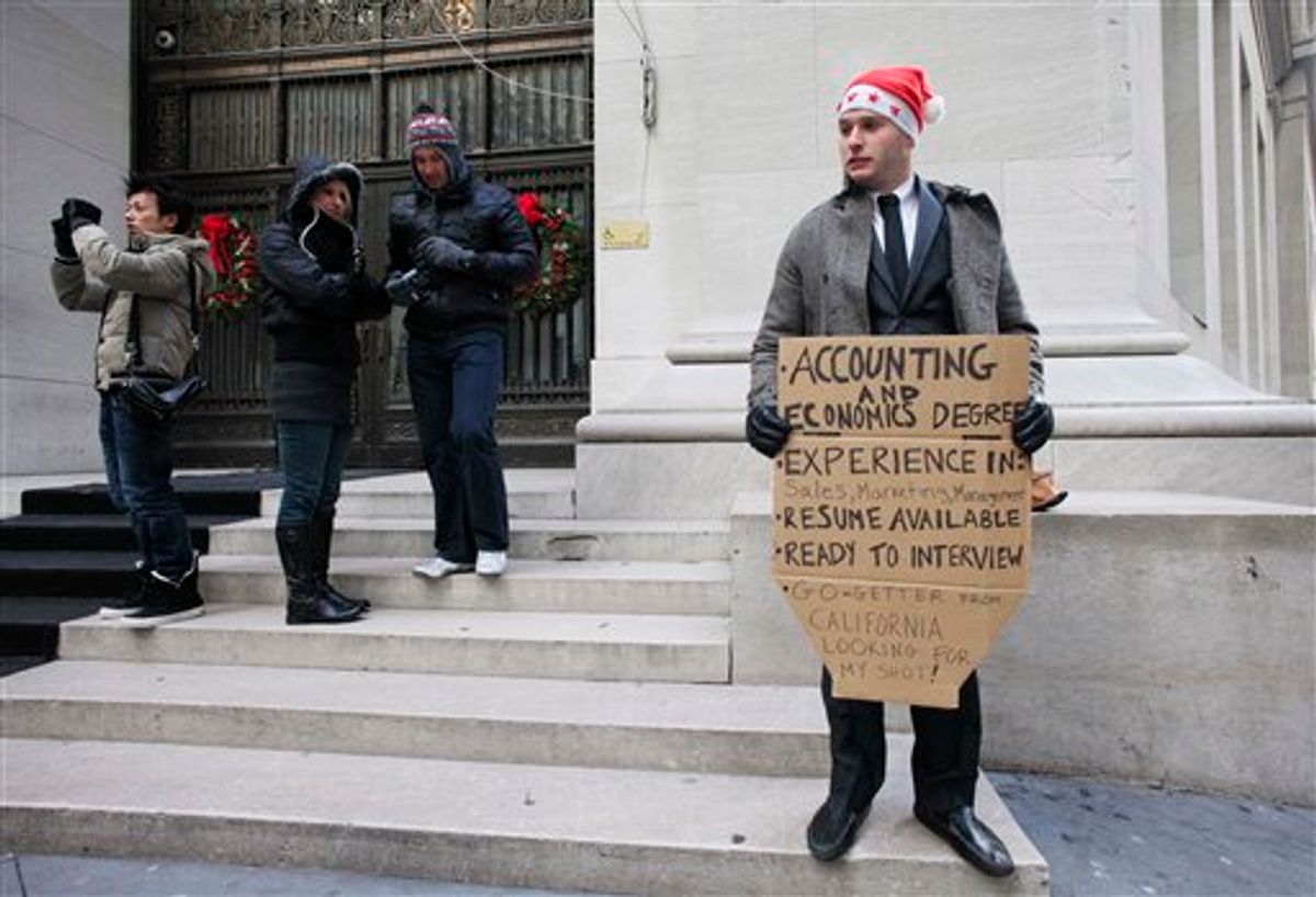 In this Dec. 15, 2010 photo, Jesse Paloger holds up a sign while standing on Wall Street as he hopes to find a job, in New York. Paloger, who has an accounting and economics degree from the University of California, Santa Barbara, has written on the bottom of his sign, "Go-getter from California looking for my shot!" Fewer people applied for unemployment benefits last week, the third drop in the past four weeks and a sign that the job market is slowly improving.   (AP Photo/Mark Lennihan) (AP)