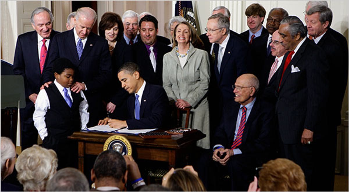 President Obama signs healthcare legislation in March 2010