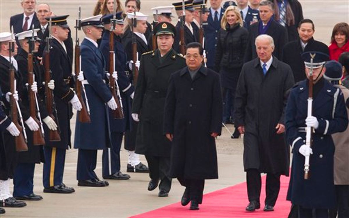 Chinese President Hu Jintao and Vice President Joe Biden walk the red carpet upon the president's arrival, Tuesday, Jan. 18, 2011, at Andrews Air Force Base, Md. (AP Photo/Evan Vucci)  (AP)