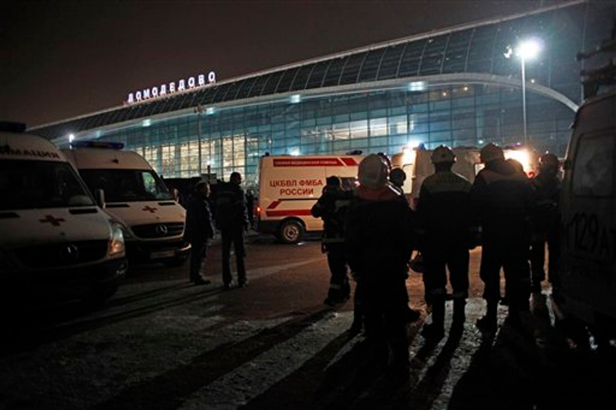 Ambulance vehicles and emergency workers are seen in front of Domodedovo airport in Moscow, Monday, Jan. 24, 2011. An explosion ripped through the international arrivals hall at Moscow's busiest airport on Monday, killing dozens of people and wounding scores, officials said. The Russian president called it a terror attack. (AP Photo/Alexander Zemlianichenko) (AP)
