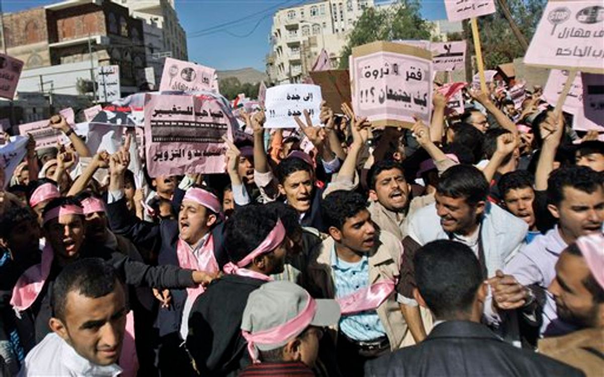 Yemeni demonstrators chant slogans during a rally  calling for an end to the government of President Ali Abdullah Saleh, in Sanaa, Yemen, Thursday, Jan. 27, 2011. Tens of thousands of people are calling for the Yemeni president's ouster in protests across the capital inspired by the popular revolt in Tunisia. The demonstrations led by opposition members and youth activists are a significant expansion of the unrest sparked by the Tunisian uprising, which also inspired Egypt's largest protests in a generation. Banners read from right: 'Together lets break the ruling party'. 'Poverty and wealth how could it work?!', 'Jeddah Jeddah', and 'Yes for change no for faking and extending'. (AP Photo/Hani Mohammed) (AP)