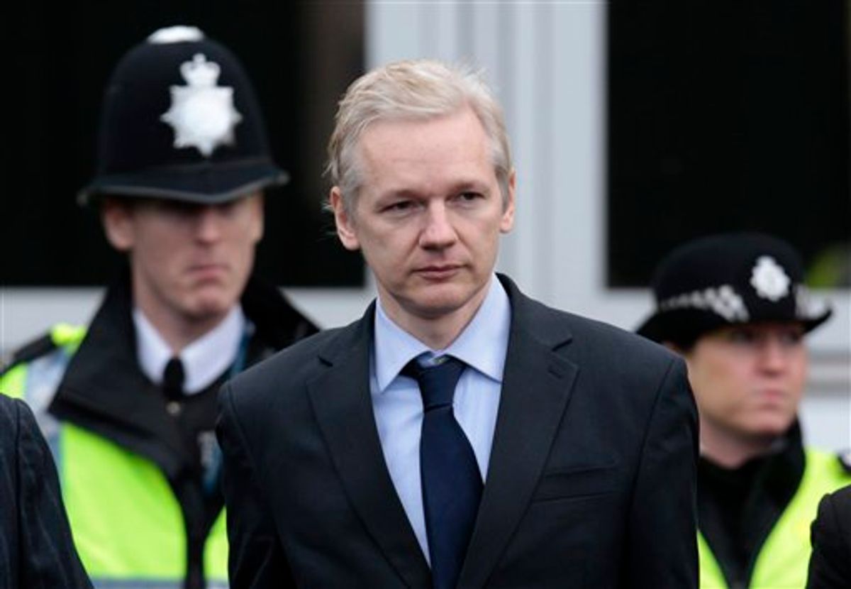 The founder of secret-spilling website WikiLeaks Julian Assange is flanked by police officers as he leaves court after making an appearance at Belmarsh Magistrates' Court in London, Tuesday, Jan. 11, 2011.  Assange is in court Tuesday for a procedural hearing which lasted for only about 10 minutes, as part of his fight to avoid extradition to Sweden on allegations of sex crimes. (AP Photo/Lefteris Pitarakis) (AP)