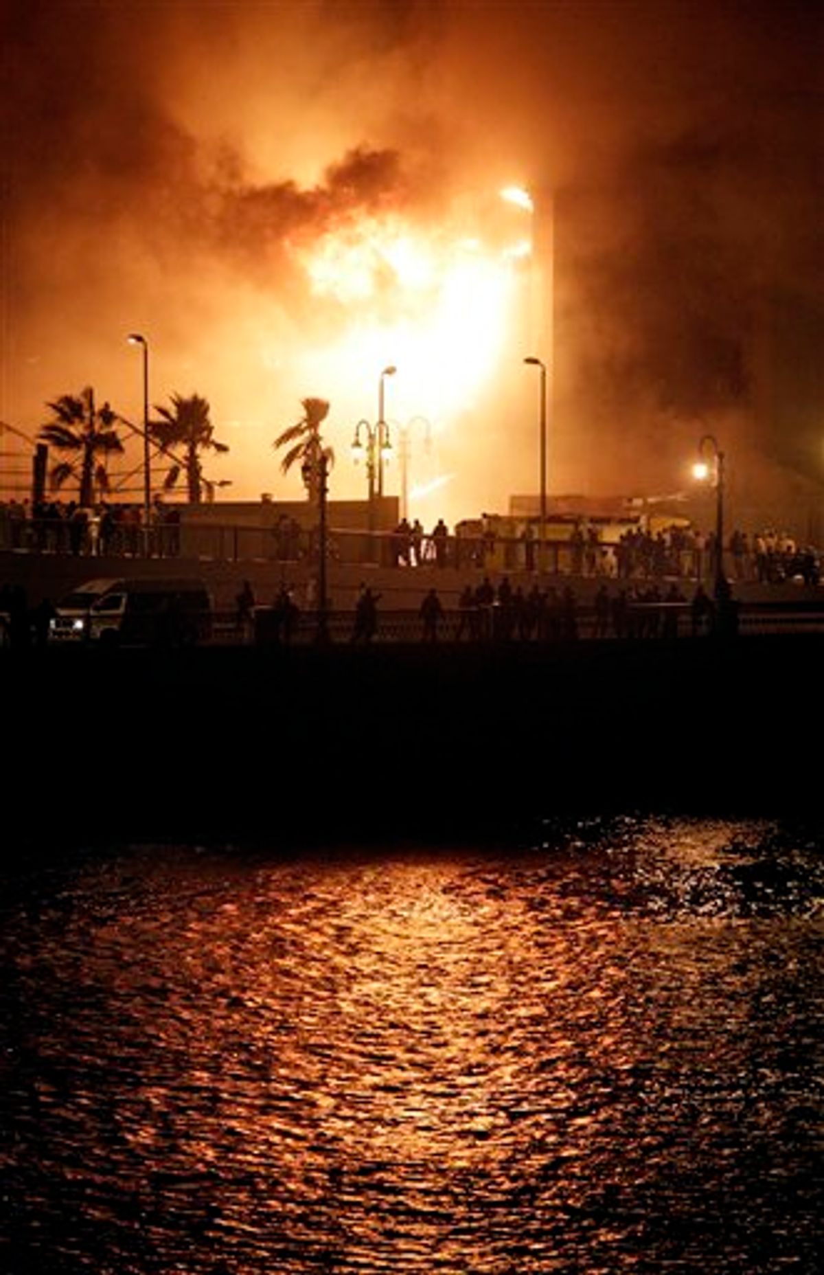 Fires burn in the National Democratic Party ruling party headquarters, after it was set alight by anti-government protesters, in downtown Cairo, Egypt, Friday, Jan. 28, 2011. (AP Photo/Ben Curtis) (AP)