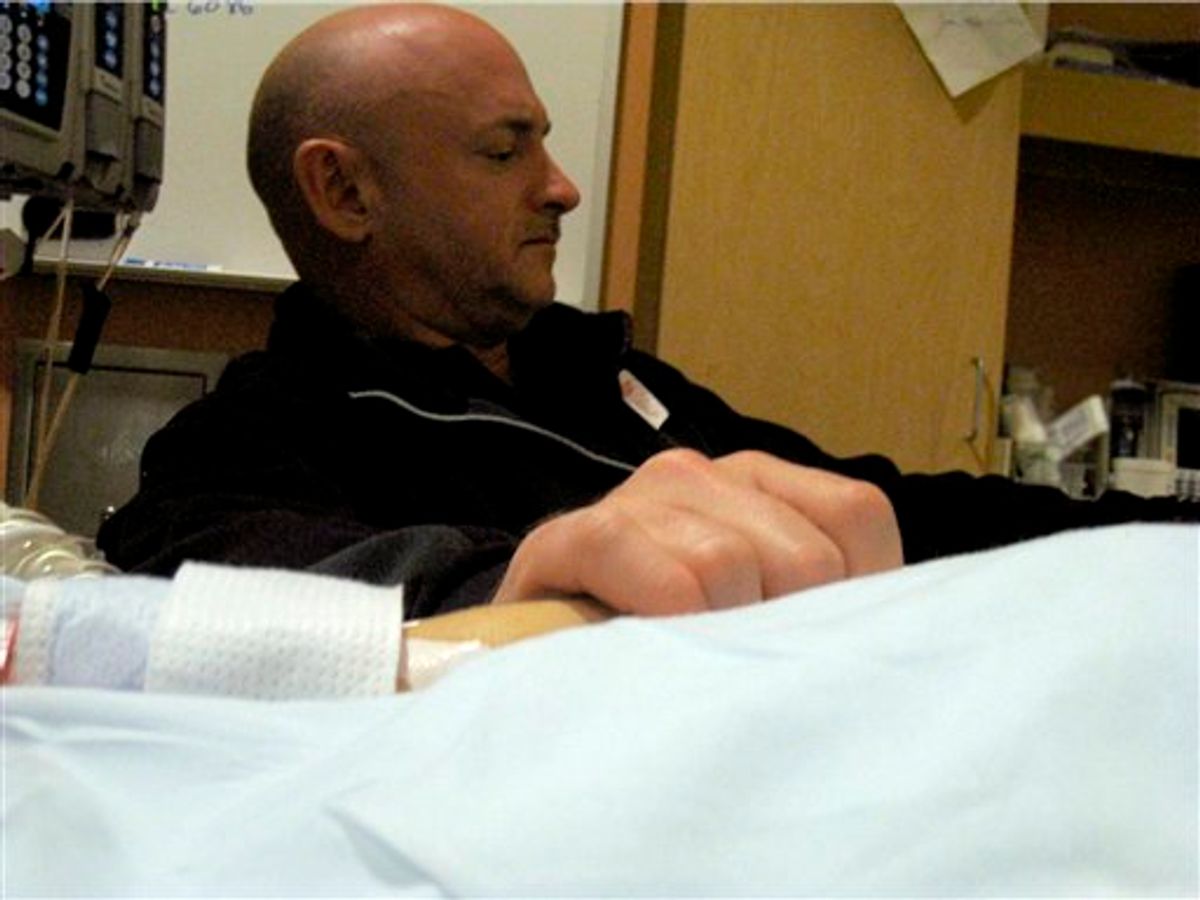 In this Sunday, Jan. 9, 2011 photo provided by the office of Rep. Gabrielle Giffords, Mark Kelly, Giffords' husband, holds the congresswoman's hand in her room at University Medical Center in Tucson, Ariz. Giffords was shot in the head during a political event in Tucson on Saturday. (AP Photo/Office of Rep. Gabrielle Giffords) (AP)