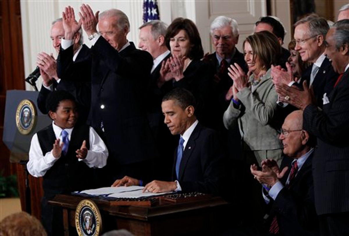 President Obama is applauded after signing the health care bill. (AP Photo/Charles Dharapak, File)  (AP)