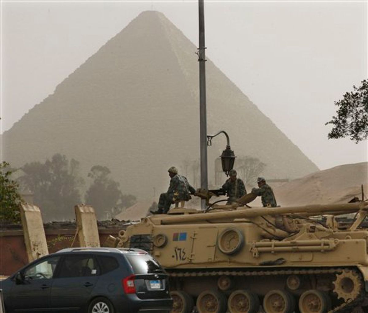An Egyptian APC vehicle drives near the Pyramids, in Giza, Egypt, Saturday, Jan. 29, 2011. The Pyramids are closed to tourists. (AP Photo/Victoria Hazou) (AP)