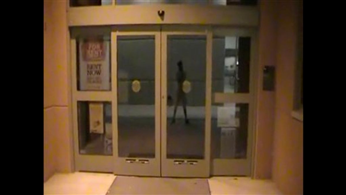In this image taken from a YouTube video posted by Jared Lee Loughner and released by Pima Community College to the Associated Press , a campus books  station is shown at Pima Community College, with the reflection of Loughner  in Tucson, Ariz. The video shot by the suspected gunman in the attack on Rep. Gabrielle Giffords and others showed the former community college student touring campus at night and at times rambling about free speech and the Constitution.  (AP Photo/Pima Community College) (AP)