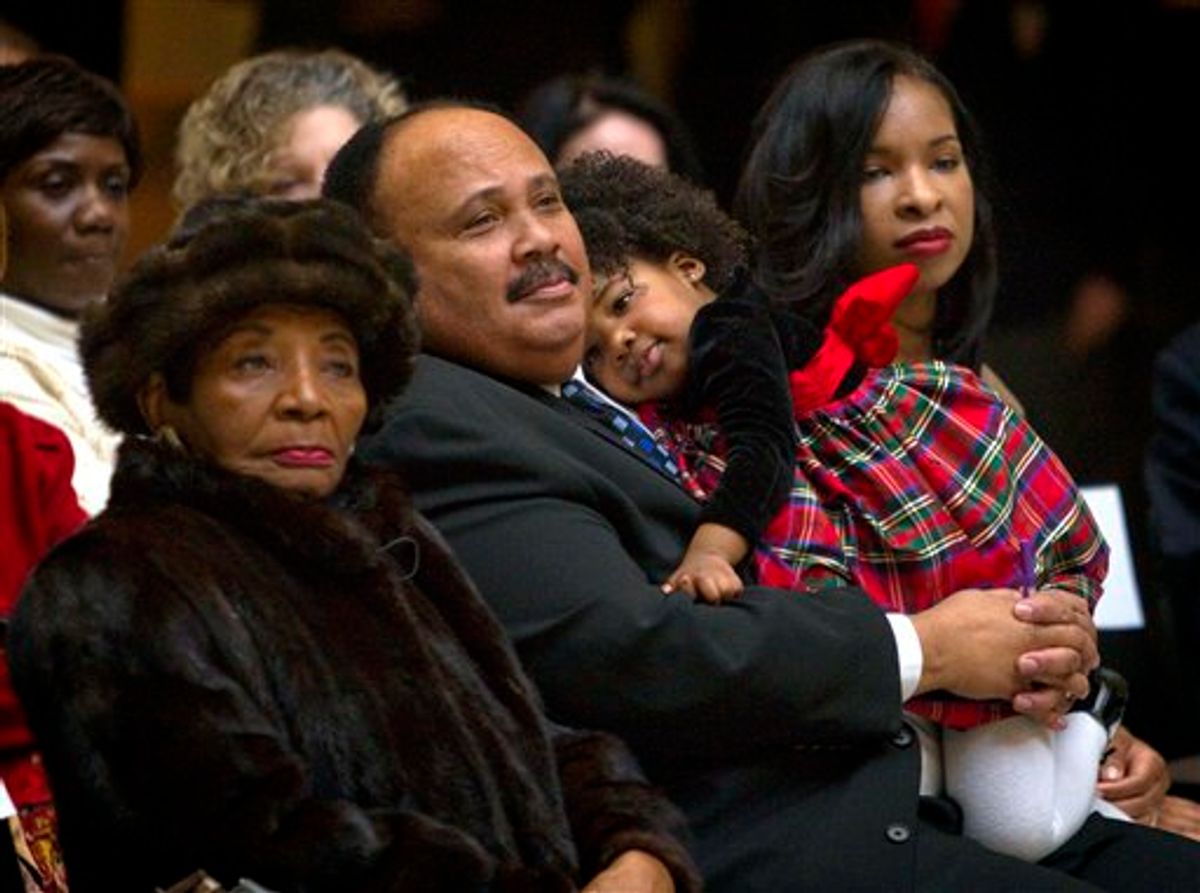 Christine King Farris, from left, the only living sibling of Dr. Martin Luther King Jr., along with Dr. King's son, Martin Luther King III, his daughter Yolanda, 2, and wife Arndrea, look on during a ceremony honoring the late civil rights leader in the State Capitol Thursday, Jan. 13, 2011, in Atlanta. The nation will mark the 25th federal observance of King's birthday on Monday. (AP Photo/David Goldman) (AP)