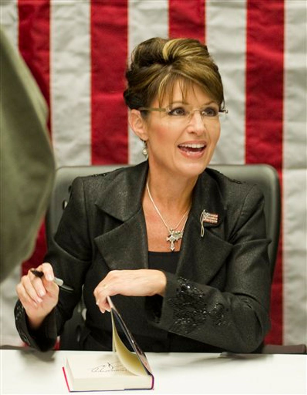 FILE - In a Nov. 30, 2010 file photo, Sarah Palin signs copies of her new book, "America By Heart," in Little Rock, Ark. Palin has posted a nearly eight-minute video on her Facebook page condemning those who blame political rhetoric for the Arizona shooting that gravely wounded U.S. Rep. Gabrielle Giffords.  In the video posted Wednesday, Dec. 12, 2010, the 2008 GOP vice presidential candidate said vigorous debates are a cherished tradition. But she said after the election, both sides find common ground, even though they disagree.  (AP Photo/Brian Chilson, File) (AP)