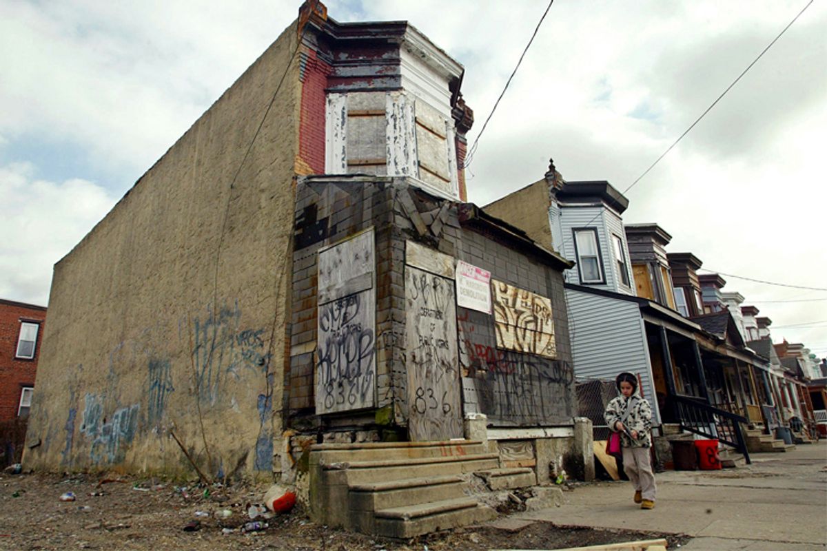 A young girl walks by abandoned buildings in Camden, New Jersey.