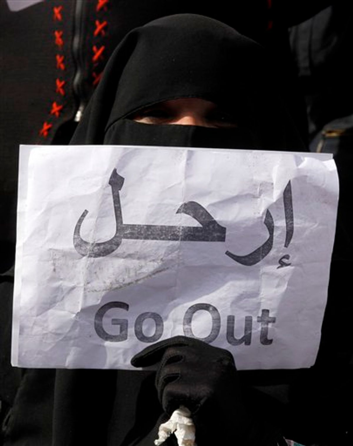 A veiled woman holds a poster calling for President Hosni Mubarak to go, in Tahrir, or Liberation, Square in Cairo, Egypt, Tuesday, Feb. 1, 2011. Tens of thousands of people flooded into the heart of Cairo Tuesday, filling the city's main square as a call for a million protesters was answered by the largest demonstration in a week of unceasing demands for President Hosni Mubarak to leave after nearly 30 years in power. (AP Photo/Victoria Hazou) (AP)