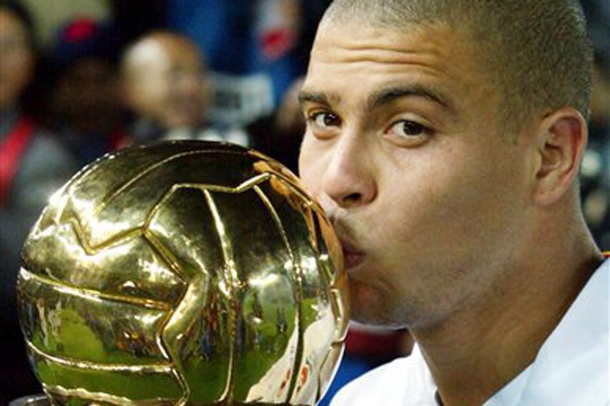 FILE - In this Dec. 3, 2002, file photo, European champion Real Madrid ace striker Ronaldo plants a jubilant kiss on the Intercontinental Cup trophy after winning the Toyota Cup against its South American counterpart Olimpia in Yokohama, southwest of Tokyo, Japan.  Ronaldo said on Monday, Feb. 14, 2011, he is retiring from soccer because he can't stay fit anymore, ending a stellar 18-year career in which he thrived with Brazil and some of Europe's top clubs. (AP Photo/Itsuo Inouye, file) (Itsuo Inouye)