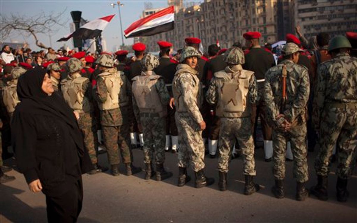 Egyptian army military police and army soldiers form a line to clear protesters from the street and enable vehicles to pass in Tahrir Square in downtown Cairo, Egypt, Sunday, Feb. 13, 2011. Egypt's military is taking down the makeshift tents of protesters who camped out on Tahrir Square in an effort to allow traffic and normal life to return to central Cairo. There were a few verbal altercations between soldiers and protesters Sunday morning as the tents were removed, but the process was generally peaceful.  (AP Photo/Emilio Morenatti) (AP)