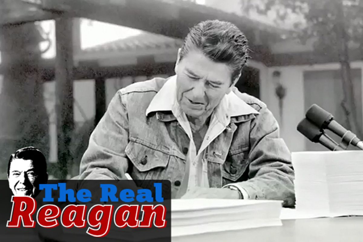 Former President Reagan signs the Economic Recovery Tax Act of 1981