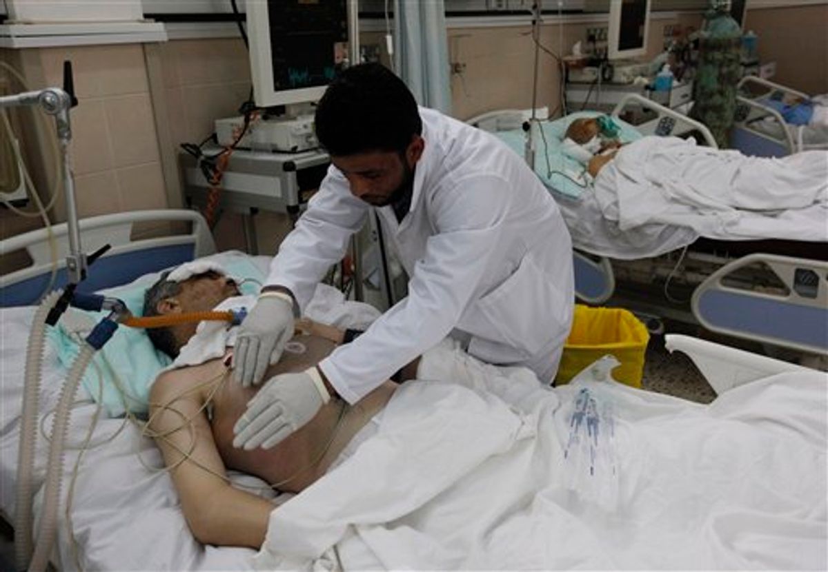 A Libyan doctor treats a wonded man who was injured last week during the demostration against Libyan leader Moammar Gadhafi, in Benghazi, Libya, on Thursday Feb. 24, 20011. (AP Photo/Hussein Malla) (AP)