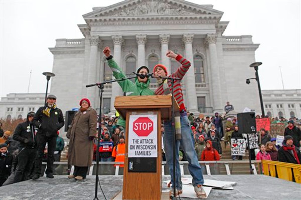 A pair of UW-Madison students fire up the crowd as sleet falls outside the state Capitol Monday, Feb. 21, 2011, in Madison, Wis. Opponents to Governor Scott Walker's bill to eliminate collective bargaining rights for many state workers are taking part in their seventh day of protesting.  (AP Photo/Jeffrey Phelps)  (AP)
