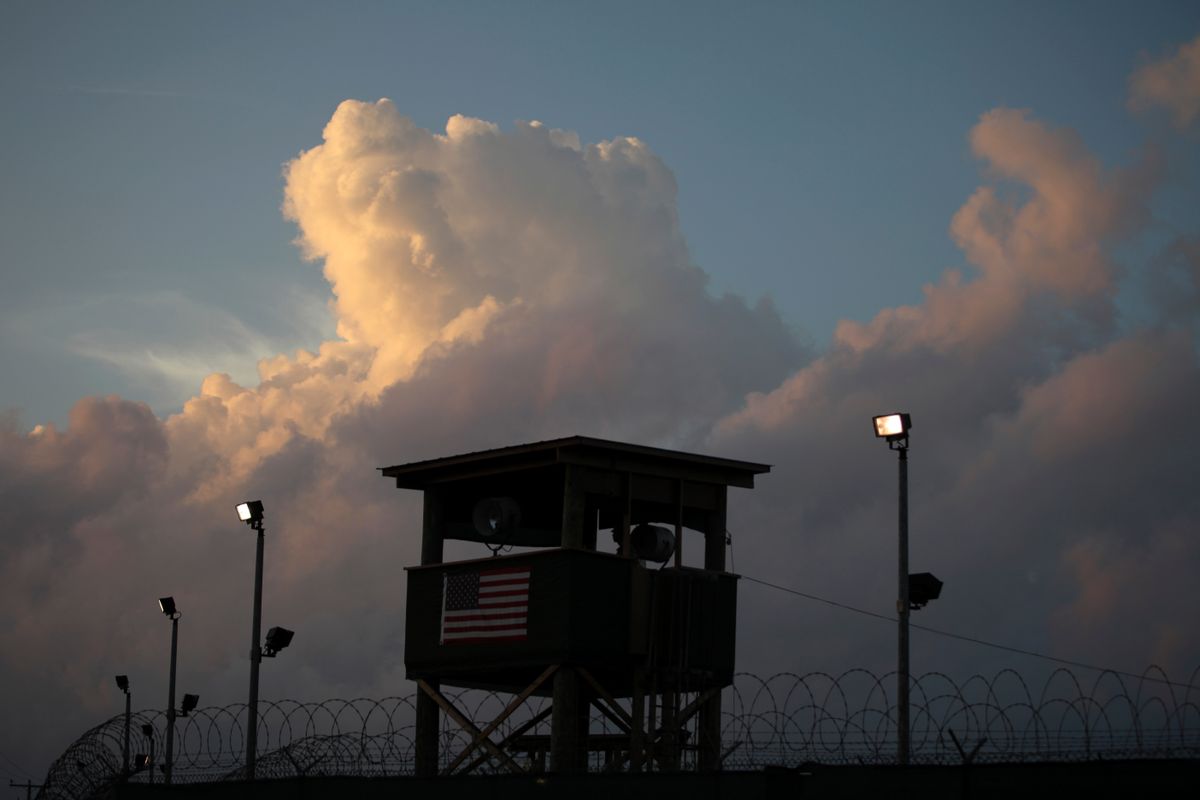 A guard looks out from a tower in front of the detention facility on Guantanamo Bay U.S. Naval Base in Cuba.   (Associated Press)