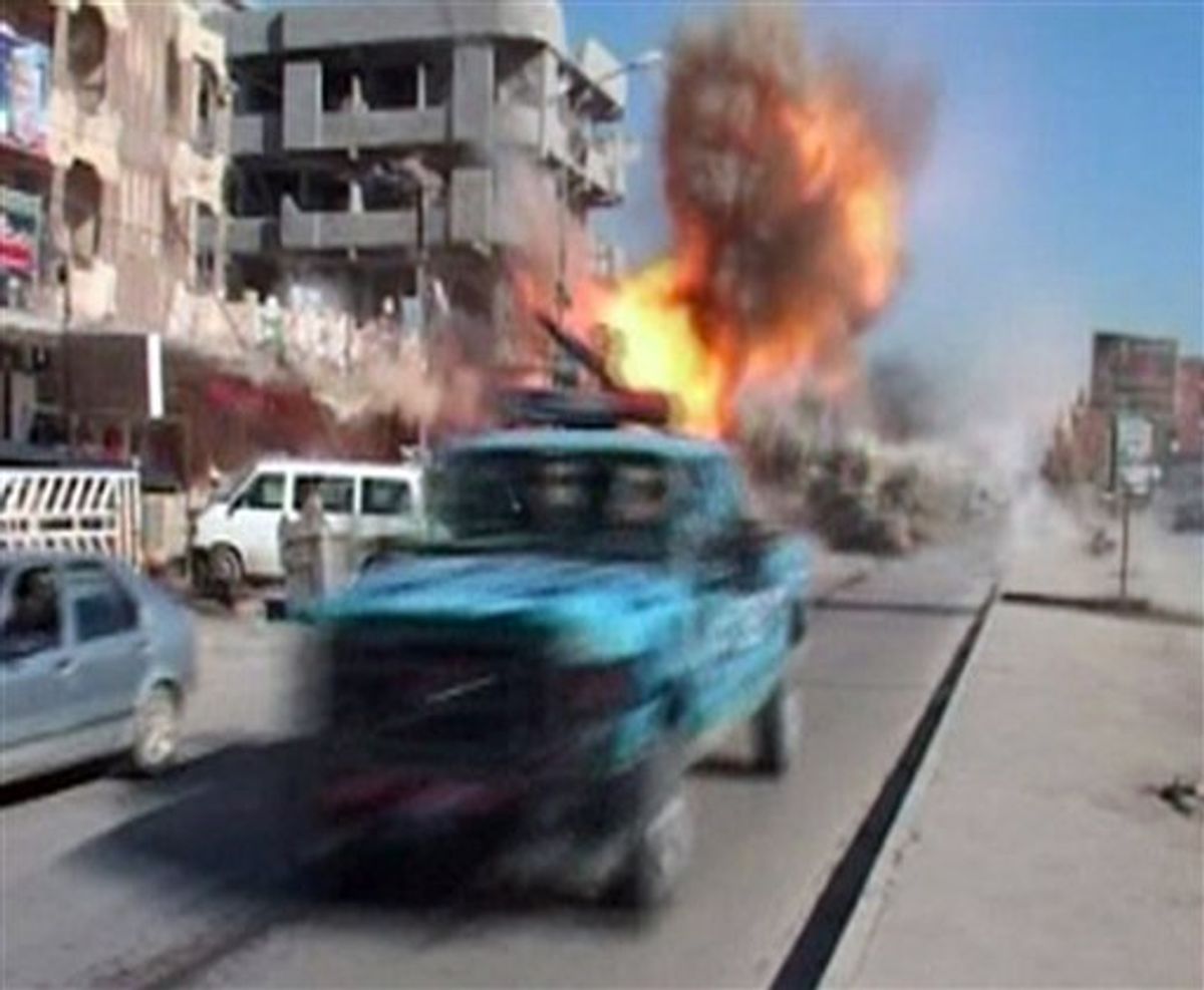 In this image from TV showing the moment that a bomb detonates on a street in Kirkuk, Iraq, on Wednesday Feb. 9, 2011, as security forces and emergency vehicles pass along the main road on their way to attend the scene of another explosion. The bomb exploded while news cameraman Imad Mitti filmed street scenes and the blast knocked him off his feet, but he was unhurt in the explosion.  Car bombs ripped through the oil-rich Iraqi city of Kirkuk on Wednesday, killing at least six and wounding some 35 others in the heart of a region of long-simmering ethnic tensions.(AP Photo / Imad Mitti, APTN) (AP)