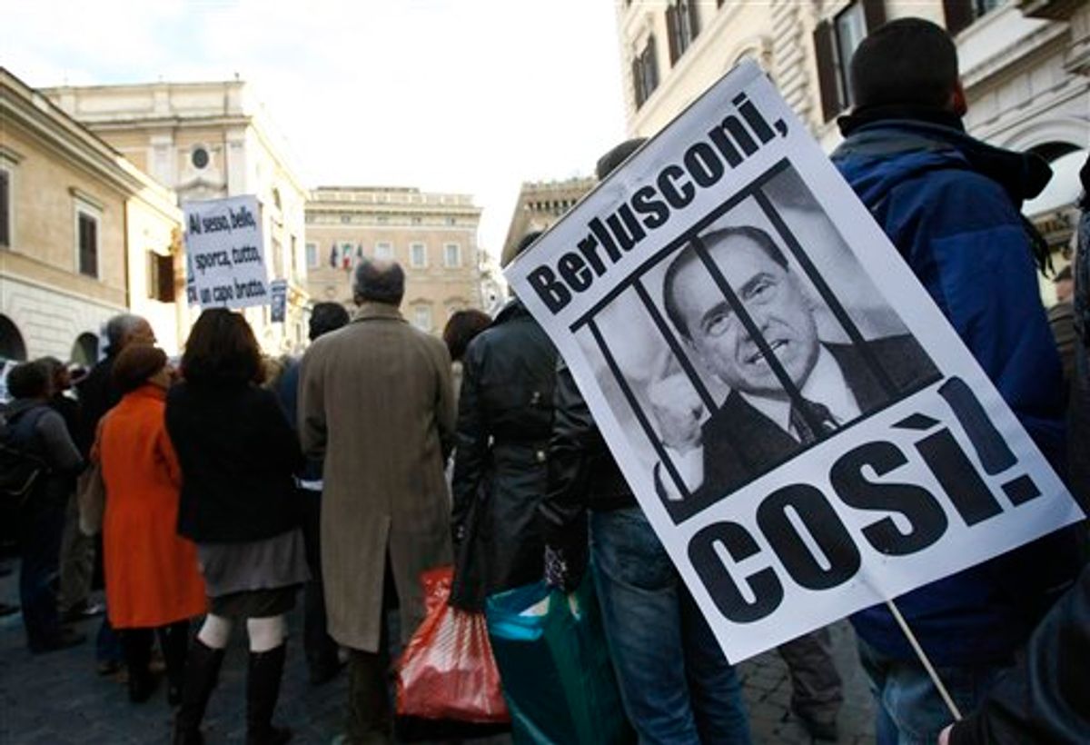 A demonstrator holds a banner with a picture of a caged Berlusconi during a protest against Italian Premier Silvio Berlusconi, in Rome, Saturday, Feb.12, 2011. Protestors are demanding Berlusconi's resignation following allegations he paid for sex with a 17-year-old girl and used his office to cover it up. Italian prosecutors want to put Italian Premier Berlusconi on trial for the allegations. Berlusconi has dismissed the allegations as a smear campaign. "I'm not worried in the slightest," Berlusconi said of the prostitution case. "I am a wealthy gentleman who can spend the rest of his life building hospitals for children like I've always wanted to." The banner reads: "Berlusconi, like this!". (AP Photo/Pier Paolo Cito)        (AP)