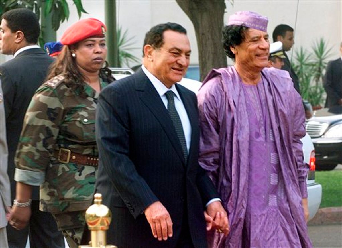 FILE.- This July 21, 2002  file photo shows Egyptian President Hosni Mubarak, center, welcoming Libyan leader Moammar Gadhafi, right, who is guarded by a female bodyguard, left, upon his arrival at the Presidential Palace in Cairo. Hundreds of Libyans calling for the government's ouster took to the streets early Wednesday in the country's second-largest city as Egypt-inspired unrest spread to the country long ruled by Moammar Gadhafi. (AP Photo/Amr Nabil)  (AP)