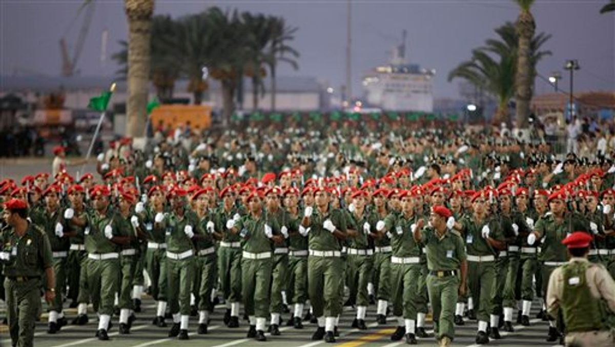 FILE - In this Tuesday, Sept. 1, 2009 file photo, Libyan military parade at a celebration attended by Libyan Leader Moammar Gadhafi in Green Square, Tripoli, Libya. Libyan special forces stormed a two-day-old protest encampment in the country's second largest city of Benghazi, clearing the area early Saturday, Feb. 19, 2011, said witnesses, as a human rights group estimate scores of people have died in the harsh crackdown on days of demonstrations. (AP Photo/Ben Curtis, File) (AP)
