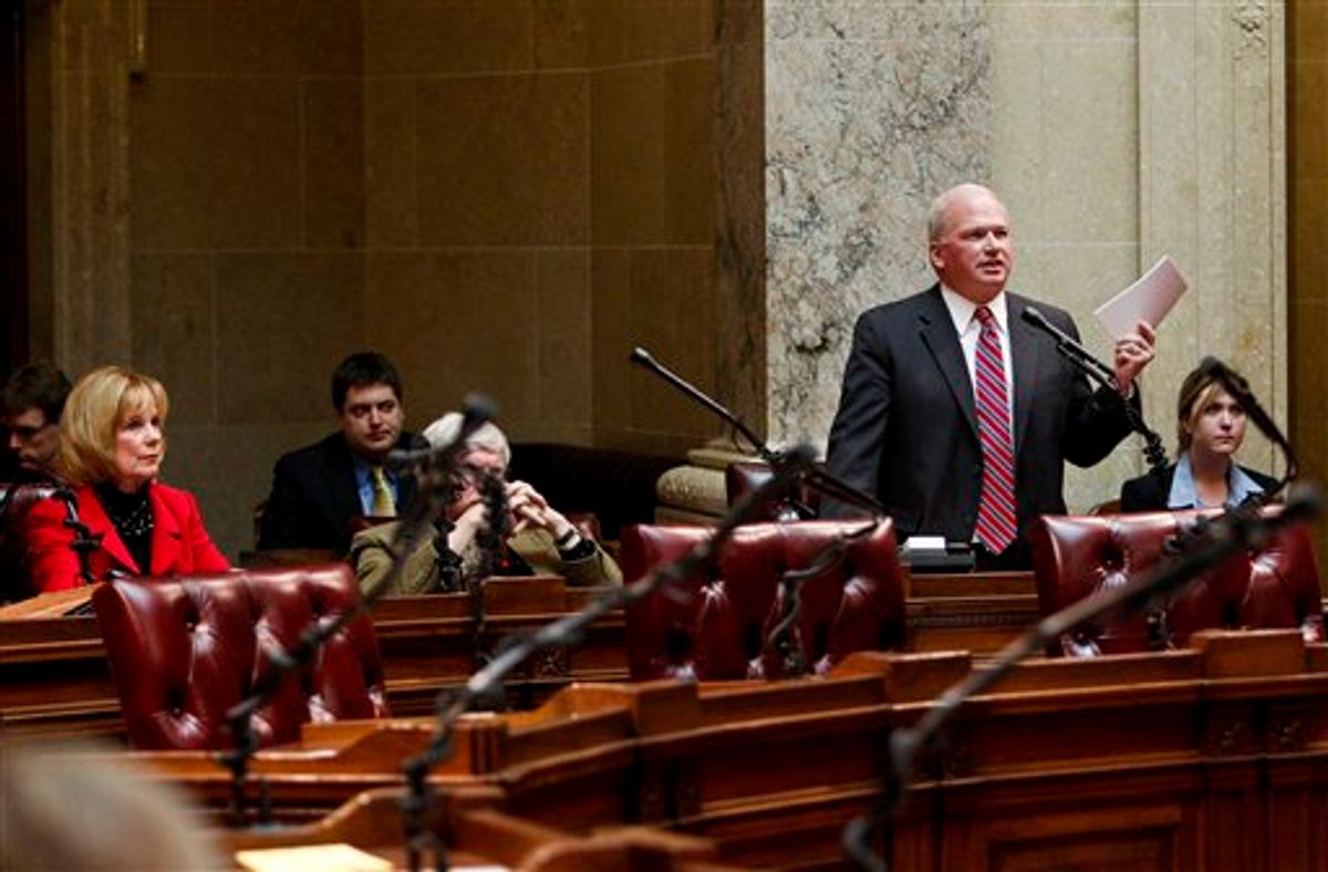 Wisconsin Majority Leader Scott Fitzgerald, standing right, R-Juneau, talks about the rules in the senate handbook during debate on floor at the state Capitol in Madison, Wis., Wednesday, Feb. 23, 2011. Fourteen democratic Senators are in undisclosed locations effectively stalling the governor's budget proposal. Opponents to the governor's bill to eliminate collective bargaining rights for many state workers on their ninth day of protests at the Capitol.  (AP Photo/Andy Manis) (AP)