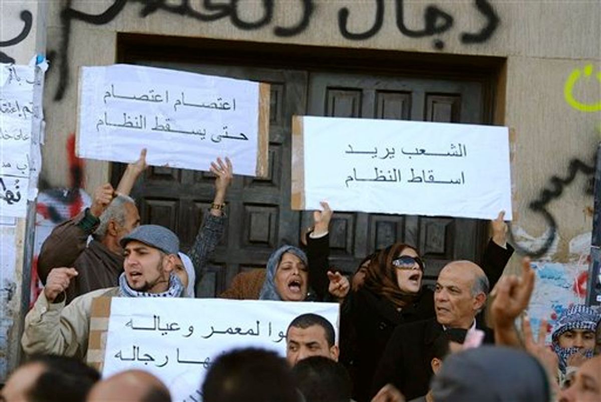 This photograph, obtained by The Associated Press outside Libya and taken by an individual not employed by AP, shows people chanting and holding signs during recent days' unrest in Benghazi, Libya.  Placards in Arabic read at top left "Strike, strike until the fall of the regime", and at top right "The people want to topple the regime".  (AP Photo) EDITOR'S NOTE: THE AP HAS NO WAY OF INDEPENDENTLY VERIFYING THE EXACT CONTENT, LOCATION OR DATE OF THIS IMAGE. (AP)