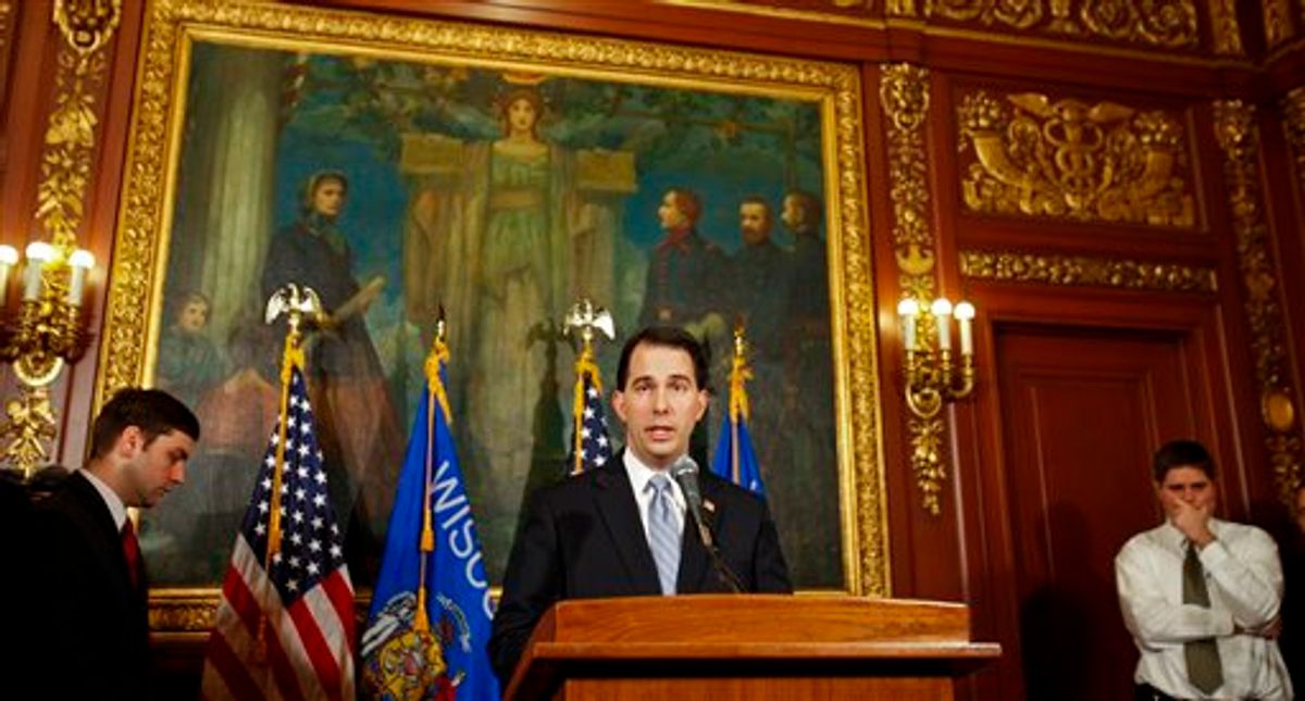 Wisconsin Gov. Scott Walker talks to the media at the state Capitol in Madison, Wis., Wednesday, Feb. 23, 2011. Opponents to the governor's proposal to eliminate collective bargaining rights for many state workers are in their ninth day of protests at the Capitol.  (AP Photo/Andy Manis) (AP)
