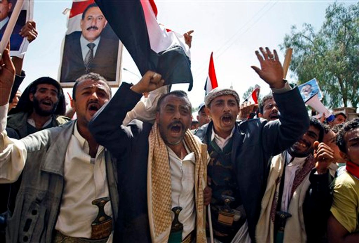Supporters of the Yemeni government shout slogans as they try to enter Sanaa University where anti-government protestors gather, in Sanaa, Yemen, Wednesday, Feb. 16, 2011. Yemen sent 2,000 policemen into the streets of the capital on Wednesday to try to put down days of protests against the president of 32 years, a key U.S. ally in battling al-Qaida.The policemen, including plainclothes officers, fired in the air and blocked thousands of students at Sanaa University from joining thousands of other protesters elsewhere in the capital who were holding a sixth straight day of demonstrations. (AP Photo/Hani Mohammed) (AP)