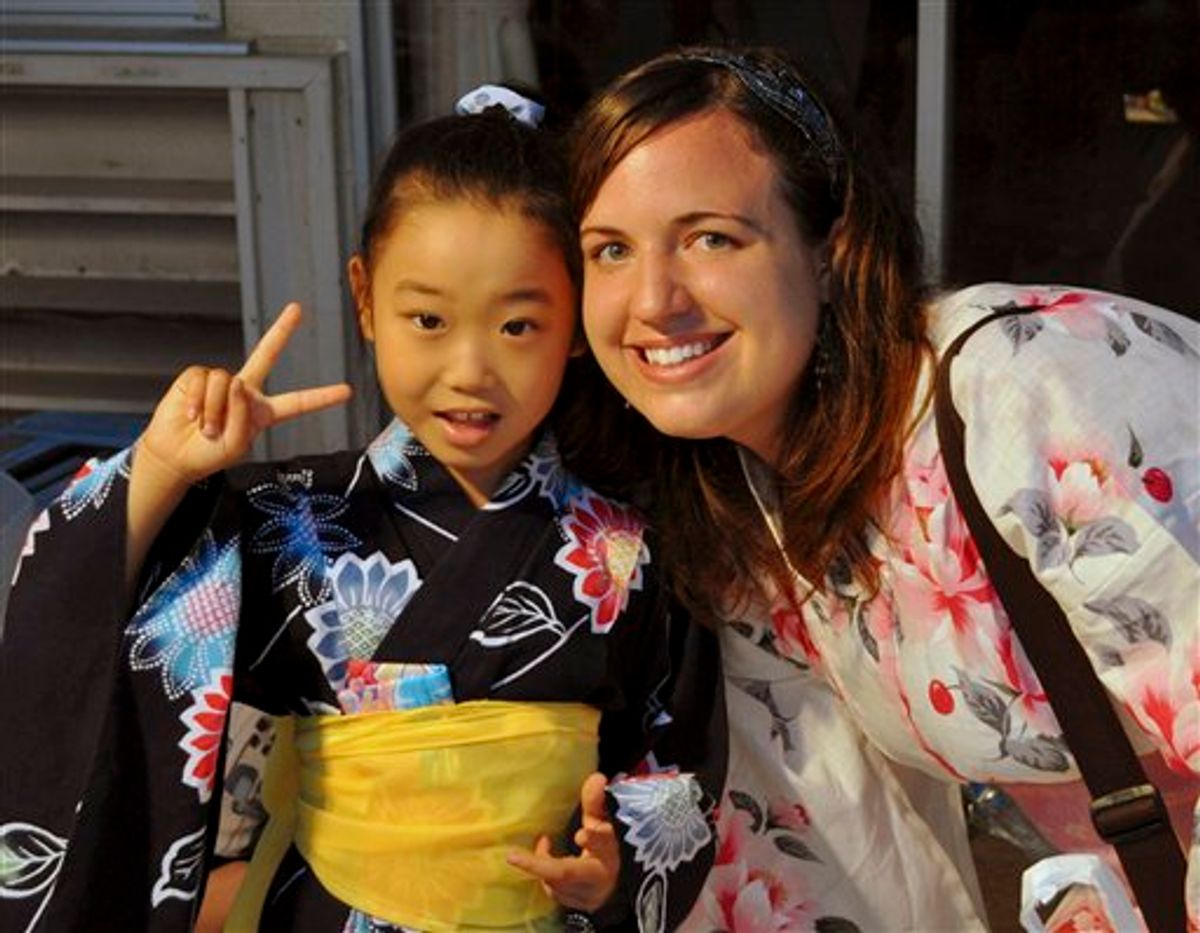 In this July 17, 2010 photo provided the Anderson family, Taylor Anderson, right, poses with one of her students in Ishinomaki, Japan, where she taught English. Anderson's family said in a statement that the U.S. Embassy in Japan on Monday, March 21, 2011 informed them by telephone of the discovery of their 24-year-old daughter's body. (AP Photo/Anderson Family) NO SALES (AP)
