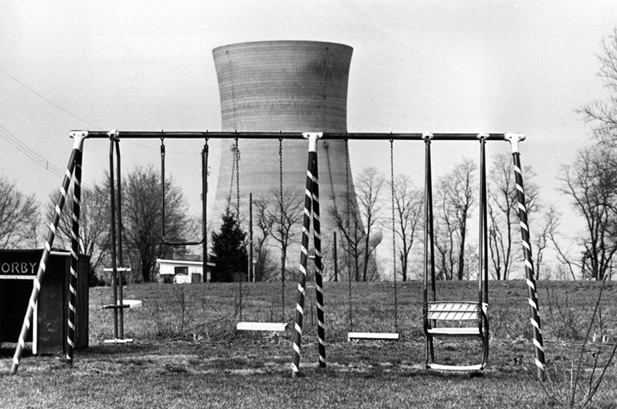 A cooling tower of the Three Mile Island nuclear power plant near Harrisburg, Pa., looms behind an abandoned playground, March 30, 1979.  (AP Photo/Barry Thumma) (Barry Thumma)