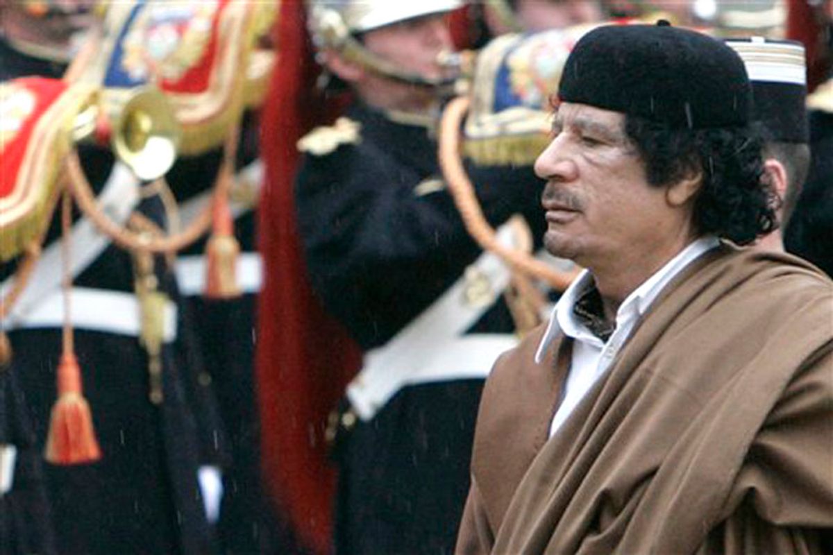 Libyan leader Col. Moammar Gadhafi reviews the French Republican Guard upon his arrival at the Elysee Palace for a meeting with French President Nicolas Sarkozy, in Paris, Monday, Dec. 10, 2007. Gadhafi takes a giant stride toward international respectability Monday, making a visit to France likely to conclude with deals worth millions, but drawing protests, including from a government minister. (AP Photo/Christophe Ena) (Christophe Ena)