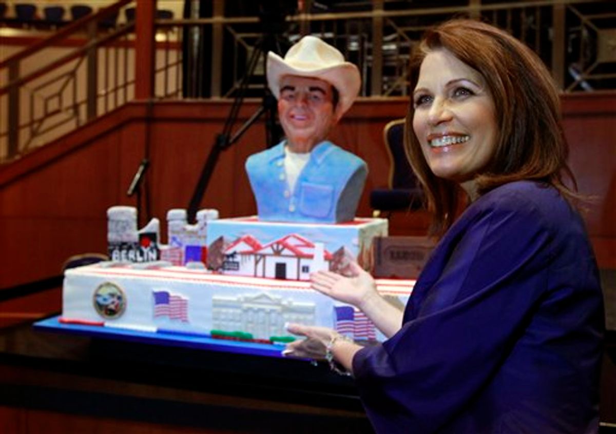 Rep. Michele Bachmann, R-Minn., poses for a picture with a birthday cake for President Ronald Reagan at the Conservative Political Action Conference (CPAC) in Washington, Thursday, Feb. 10, 2011.(AP Photo/Alex Brandon) (AP)