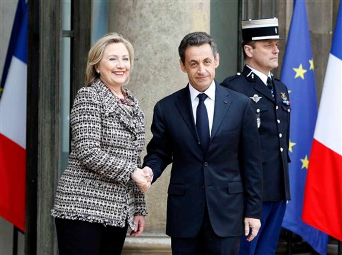 U.S Secretary of State Hillary Clinton, left, is welcomed by French President Nicolas Sarkozy for a crisis summit on Libya, at the Elysee palace in Paris, Saturday, March, 19, 2011. Britain and France took the lead in plans to enforce a no-fly zone over Libya on Friday, sending British warplanes to the Mediterranean and announcing a crisis summit in Paris with the U.N. and Arab allies. (AP photo/Remy de la Mauviniere) (AP)
