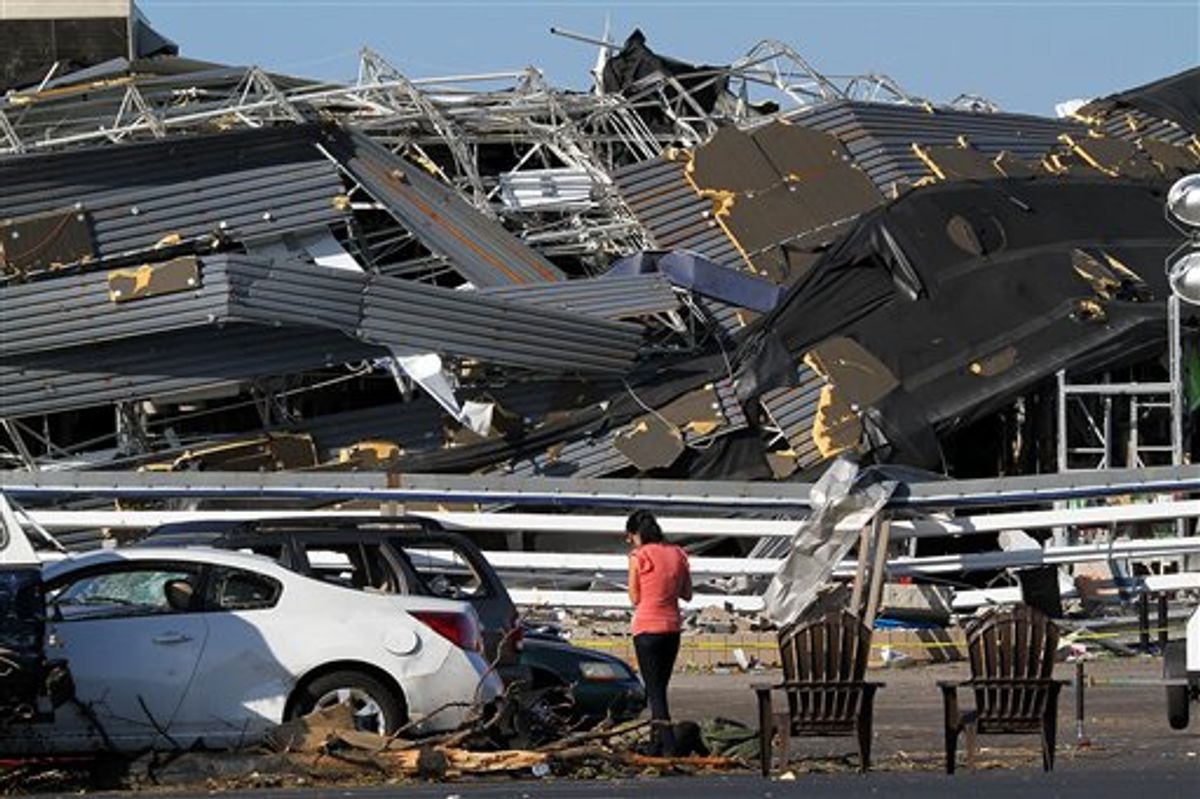 Annina Purdy, who was inside the Lowe's hardware store in Sanford, N.C. the previous day when a tornado destroyed the building, returned to the store's parking lot on Sunday, April 17, 2011, to reclaim personal belongings from her car. (AP Photo/Ted Richardson)  (AP)