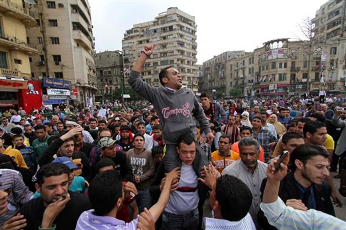 Protesters chant slogans as they march following an attack by security forces in Tahrir Square, in Cairo, Egypt, Saturday, April 9, 2011. Demonstrators burned cars and barricaded themselves with barbed wire inside a central Cairo square demanding the resignation of the military's head after troops violently dispersed an overnight protest killing one and injuring scores. (AP Photo/Khalil Hamra) (AP)