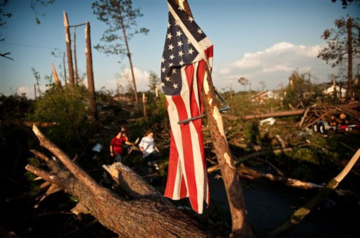 Will Harrison's flag hangs from a fallen tree after it was blown off his house when a tornado ripped through the Cottonade neighborhood Saturday, April 16, 2011 in Fayetteville, N.C. Homes and businesses were badly damaged Saturday by a severe storm system that whipped across North Carolina, bringing flash floods, hail and reports of tornadoes from the western hills to the streets of Raleigh. (AP Photo/The Fayetteville Observer, Andrew Craft) MANDATORY CREDIT; MAGS OUT; NO SALES   (AP)