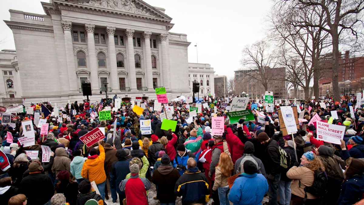 Crowds listen as Michael Moore makes a speech at the state Capitol in Madison, Wis., Saturday, March 5, 2011, on the 18th day of protests over the governor's proposed budget that would eliminate collective bargaining rights for many state workers. (AP Photo/Andy Manis) (Andy Manis)